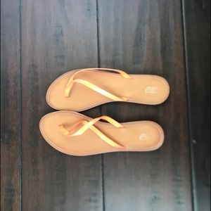 Tan and coral slip flops